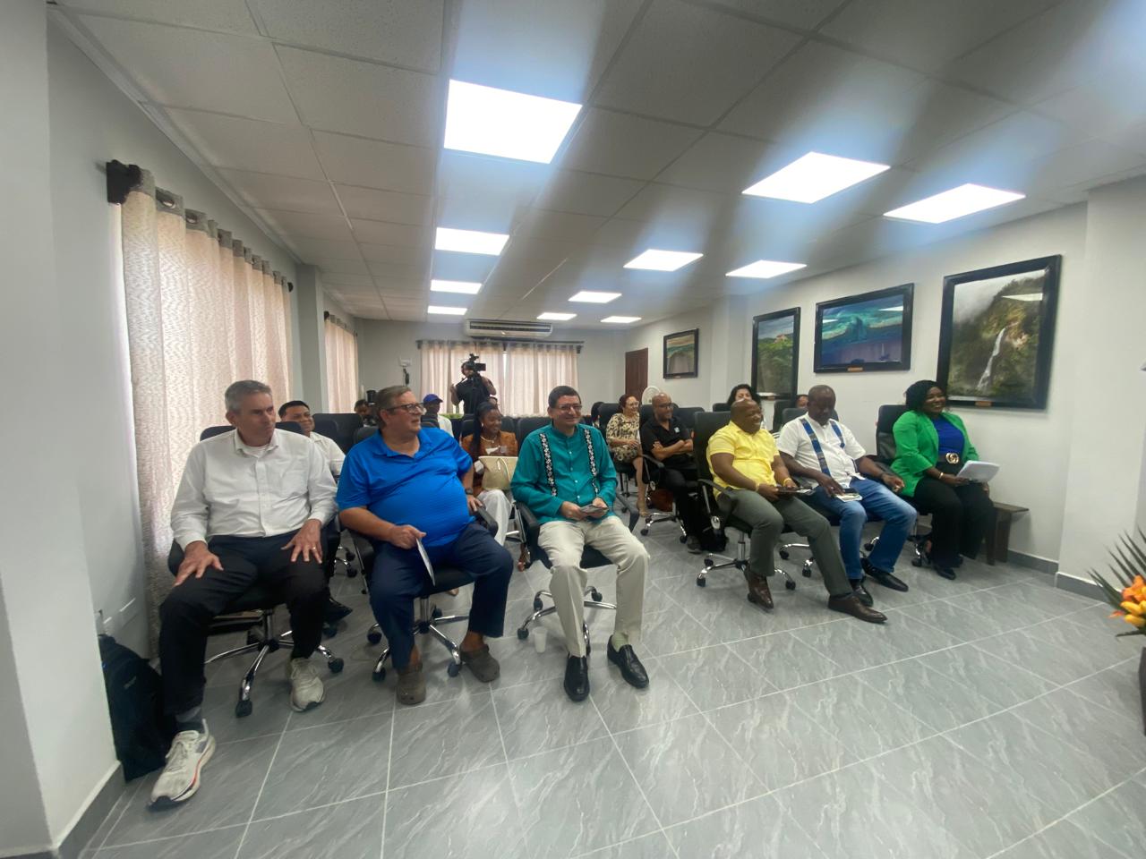 Invited guests seated at a BUILD event while a camera operator films
